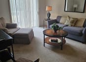 Thumbnail 19 of 22 - a living room with a couch and a table