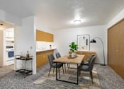 Thumbnail 2 of 10 - A dining area with a table and chairs.