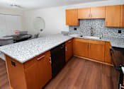 Thumbnail 1 of 12 - Kitchen with Tile Backsplash at Gray Estates Apartments, MRD Conventional, St Clair MI 48079