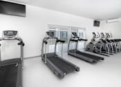Thumbnail 11 of 12 - Cardio Machines In Gym at Gray Estates Apartments, MRD Conventional, St Clair MI 48079