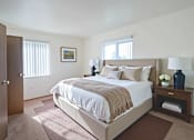 Thumbnail 9 of 15 - A bedroom with a large bed and a painting on the wall.