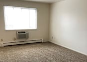 Thumbnail 11 of 15 - an empty room with a window and a radiator