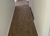 Thumbnail 5 of 9 - a hallway with a carpeted floor and white walls and a window