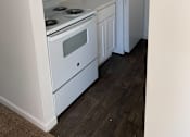 Thumbnail 3 of 9 - a kitchen with a stove and a refrigerator