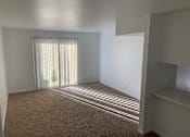 Thumbnail 1 of 9 - an empty living room with a sliding glass door