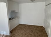 Thumbnail 4 of 9 - an empty room with a sink and a counter in it