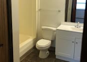 Thumbnail 14 of 15 - a bathroom with a toilet sink and bathtub