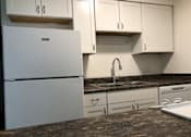 Thumbnail 8 of 15 - a kitchen with a sink and a refrigerator