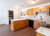 Thumbnail 3 of 14 - A kitchen with wooden cabinets and a marble countertop.