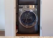 Thumbnail 4 of 14 - A washing machine is built into a cabinet.