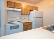 Thumbnail 5 of 5 - an empty kitchen with a stove refrigerator and sink
