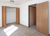 Thumbnail 1 of 5 - an empty room with two doors and a closet
