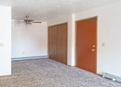 Thumbnail 3 of 8 - an empty room with a ceiling fan and two doors
