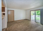 Thumbnail 3 of 10 - an empty living room with a sliding glass door to a patio