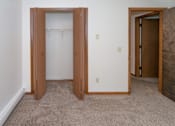 Thumbnail 7 of 10 - an empty bedroom with a closet and a door to a bathroom