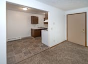 Thumbnail 9 of 10 - an empty kitchen with a door open to the living room