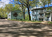 Thumbnail 2 of 10 - two houses on the side of a street with trees