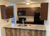 Thumbnail 15 of 15 - a kitchen with a sink a stove and a refrigerator