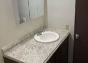 Thumbnail 14 of 15 - a bathroom with a sink and a mirror