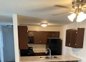 Thumbnail 13 of 15 - a kitchen with a sink and a stove in a house