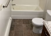 Thumbnail 11 of 15 - a bathroom with a toilet and a bathtub