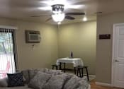 Thumbnail 9 of 12 - a living room with a couch and a table in the background