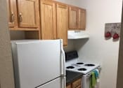 Thumbnail 8 of 12 - a kitchen with a refrigerator stove and cabinets