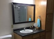 Thumbnail 7 of 12 - a bathroom with a sink toilet and mirror