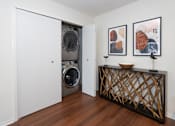 Thumbnail 5 of 17 - A laundry room with a washer and dryer in it.
