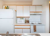 Thumbnail 13 of 17 - Kitchen with white interior at Oates Estates Apartments, Dothan, AL, 36303