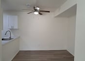 Thumbnail 6 of 8 - A room with a ceiling fan and a sink.