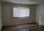 Thumbnail 8 of 8 - A room with a window covered by white curtains.