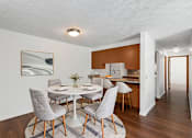 Thumbnail 5 of 20 - A dining room with a white table and grey chairs.