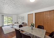 Thumbnail 4 of 20 - A dining room with a table and chairs.
