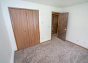 Thumbnail 6 of 11 - an empty room with two doors and a carpeted floor