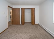 Thumbnail 8 of 11 - an empty room with a carpeted floor and two doors