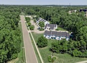 Thumbnail 4 of 24 - Aerial View Of Lush Green Property Exterior at Raleigh House Apartments, MRD Apartments, Michigan