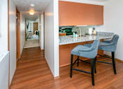 Thumbnail 11 of 24 - Fitted Kitchen With Island Dining at Raleigh House Apartments, MRD Apartments, East Lansing, Michigan
