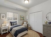 Thumbnail 8 of 9 - A bedroom with a bed, nightstand, and a chair.