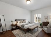 Thumbnail 7 of 9 - A bedroom with a large bed, a chair, and a small table.