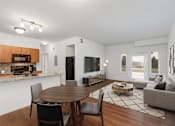 Thumbnail 6 of 9 - A modern dining room with a wooden table and chairs.
