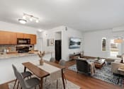 Thumbnail 2 of 9 - A modern dining room with a wooden table and chairs.