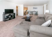 Thumbnail 9 of 12 - a living room with a large couch and a tv