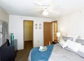 Thumbnail 8 of 12 - a bedroom with a large bed and a ceiling fan