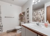 Thumbnail 6 of 12 - a bathroom with a sink and a toilet and a shower