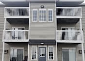Thumbnail 33 of 33 - A two-story apartment building with a balcony on each floor.