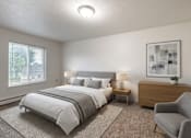 Thumbnail 5 of 10 - A bedroom with a large bed and a chair.