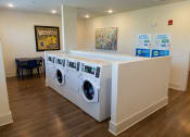 Thumbnail 31 of 35 - a washer and dryer in a laundry room