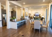 Thumbnail 21 of 35 - a dining room and living room with a table and chairs