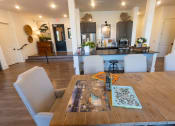 Thumbnail 26 of 35 - a dining room table with a kitchen in the background